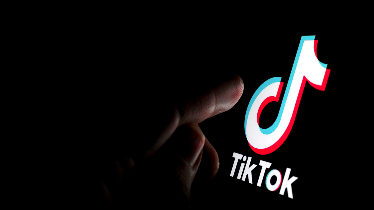 person about to press on TikTok logo on screen